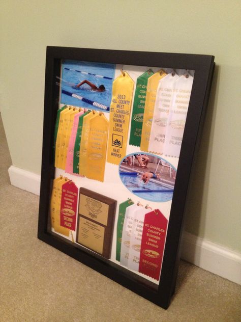 Shadow box to display awards and ribbons Track Ribbon Display Ideas, School Trophy, Award Ribbon Display, Ribbon Quilts, Swim Ribbons, Dog Shadow, Boys Bed, Memorabilia Display, Trophy Display