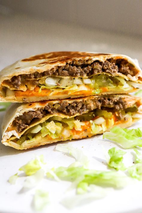 Side view of Big Mac Crunchwrap on white plate with fresh lettuce, pickles and white onions. Big Mac Crunchwrap, Big Mac Crunch Wrap, Crunch Wrap Recipe, Perfect Bar Recipe, Breakfast Crunchwrap, Crunchwrap Recipe, Homemade Big Mac Sauce, Mac Sauce Recipe, Homemade Big Mac