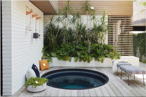 A sunken spa nestles into the corner of the courtyard, with a metal ring encircling it and concealing the cut ends of the ipe deck. The design team suggested a round tub early on in the project, both to contrast the rest of the courtyard’s mostly square design and to suggest the feeling of a Japanese soaking tub.   Glass mosaic tiles cover the spa, creating a dark and subtle space. “[It adds a] quietness and mystique,” Jones says. “It’s not bright and blue.” Round Spa, Sunken Hot Tub, Contemporary Deck, Rustic Pergola, Japanese Soaking Tubs, Hot Tub Deck, Hot Tub Backyard, Hot Tub Garden, Wooden Deck