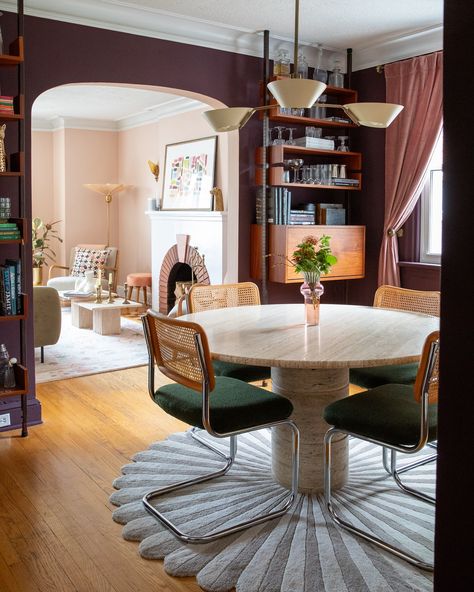 Dining Room Transformation - swipe for the before! Somehow this room feels bigger after painting the walls a rich aubergine - Brinjal by @farrowandball I felt the sideboard and square table format crowded the space and opted for a round table and sleek midcentury tension rod shelving units to allow for storage and display without taking up too much floor space. The statement mural - Mille Fleurs by @lamaisonpierrefrey inspired the palette for the entire room and welcomes every guest with ... Dark Plum Dining Room, Aubergine Accent Wall, Vintage Maximalist Dining Room, Aubergine Dining Room Walls, Plum Dining Room, Dining Room Transformation, Tension Rod, Music Room, Square Tables