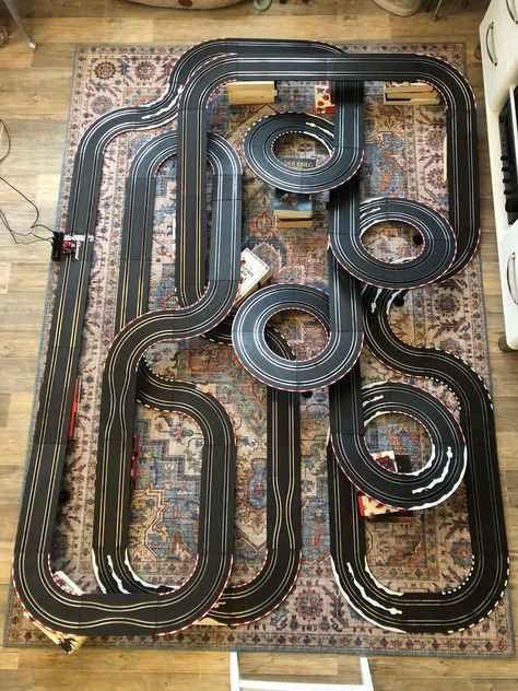 A Carrera slot car track layout on the floor. Race Tracks, Scalextric Track Layout, Rc Car Track, Hot Wheels Race Track, Slot Car, Scalextric Track, Scalextric Cars, Toy Race Track, Race Car Sets