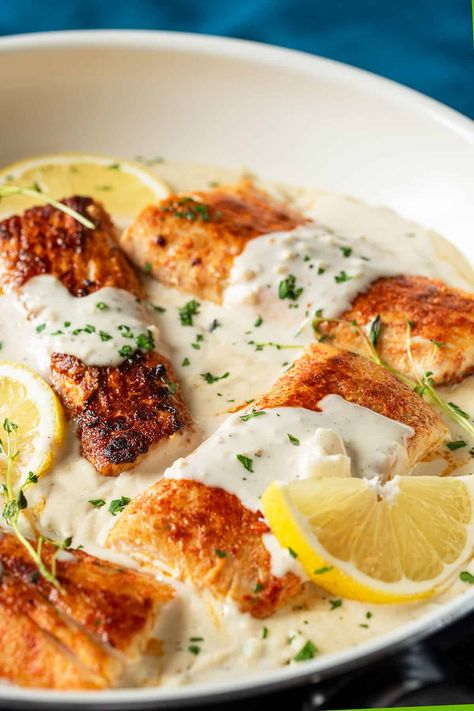 Mahi Mahi with Garlic Cream Sauce is a quick, elegant dish. Spice-rubbed Mahi fillets are pan-seared to a crisp exterior nestled in a creamy garlic and herb sauce. One pot recipe that pairs perfectly with pasta, potatoes, or green veggies! Mahi Mahi With Cream Sauce, Mahi Mahi With Potatoes, Creamy Mahi Mahi Recipes, Fish In A Cream Sauce, Crispy Mahi Mahi Recipes, Garlic Cream Sauce For Fish, Mahi Mahi With Lemon Garlic Cream Sauce, Mahi Mahi Cream Sauce, Mahi Dinner Recipes