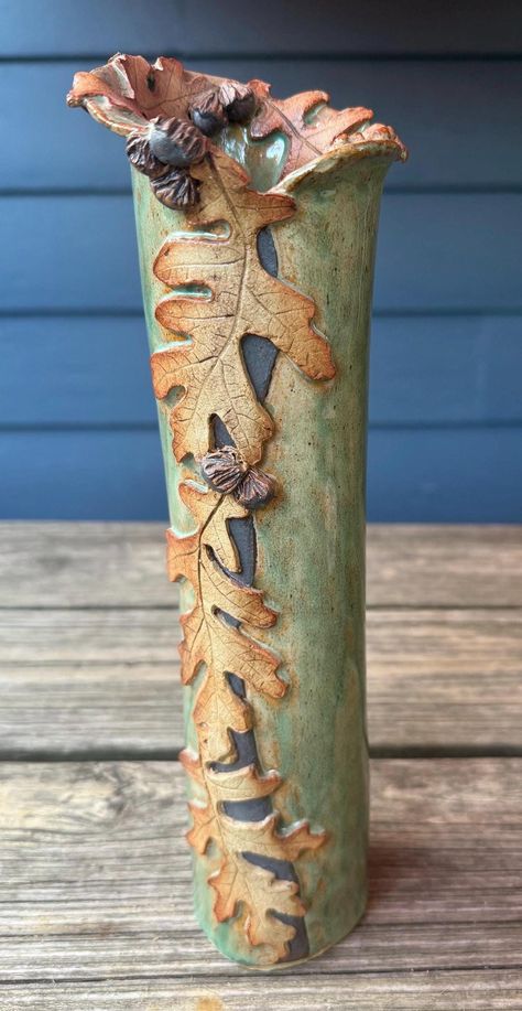 Gambrel Oak Vase from Majorie King Studio- One of a kind handmade nature theme pottery. Wheel thrown, then decorated using additions built by hand from kiln fired clay, which is made from leaves that are sculpted into clay.  Using a 14 step propriety process that takes approx. 15,000 hand stokes to complete the leaves. Marjorie is the only clay artist that has successfully mastered this technique. Each piece is unique.  All pieces are individually signed. Wheel Thrown And Hand Built Pottery, Garden Clay Ideas, Advanced Pottery Projects, Slab Pottery Ideas Creative, Slab Built Pottery Ideas, Wheel Thrown Vases, Pottery Vases Ideas Clay, Functional Ceramics Ideas, Pottery Challenge