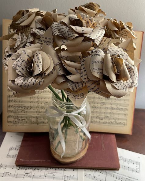 "Each hand-crafted rose is made with vintage  pages from books that have been diverted from disposal sites, recyclers, and landfills. Each rose head is approximately 3\" in diameter and just shy of 2.5\" tall. With the stem, each rose is approximately 12\" long.  This listing is for one dozen (12) roses all made from the same book for congruency. You may choose a different quantity as well.  Due to the nature of the materials, please note that each rose and each set of roses will have slight variation. These are great as centerpieces, components of a bookish wedding, or gifts to a lover or friend. For more than 2 roses please allow a couple of extra days for processing. Feel free to message me if you are in a time crunch so that I can let you know if it will be possible to meet your deadli Book Valentines Gift, Book Wedding Arch, Book Flower Bouquet, Book Themed Party Decorations, Literary Wedding Theme, Vintage Book Centerpiece, Book Wedding Centerpieces, Book Wedding Decor, Bookish Wedding