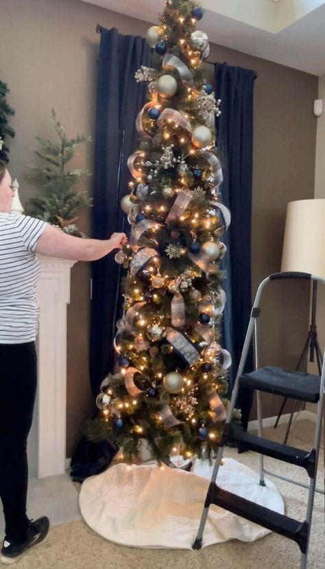 If you’ve ever considered a skinny tree, but were hesitant because you weren’t sure how to decorate it, today’s your lucky day!I created the most detailed recap of how I decorated our skinny tree in this post and the best part?It was so easy!! Let's get to it! Pre-Decorating TipsThere are a couple of things to consider before you dive into decorating your tree.First things first, you want to pick a Christmas color scheme.This will help you create a cohesive look, even if it’s just fo… Pencil Trees Decorating Ideas, Christmas Tree With Ribbon, Tree With Ribbon, Black Christmas Decorations, Christmas Tree Decorating Tips, Christmas Checklist, Christmas Colour Schemes, Slim Christmas Tree, Pencil Trees