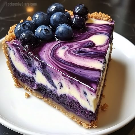 This Blueberry Swirl Cheesecake is a creamy and tangy dessert featuring a graham cracker crust, rich cheesecake filling, and sweet blueberry swirl. Peanut Fudge, Marshmallow Crème, Blueberry Swirl Cheesecake, Blueberry Crunch, Chocolate Cherry Cookies, No Bake Blueberry Cheesecake, Rich Cheesecake, Swirl Cheesecake, Sour Cream Cake