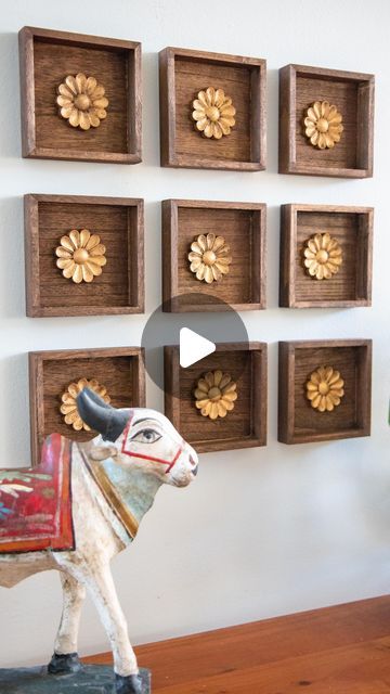 Mitesh | Home & Design on Instagram: "This was such an easy project with a big impact. I found these small wood plaques at the $1 bin @michaelsstores and knew they would work great for what I had in mind. I stained them in a walnut color along with wood rosettes from @amazon. I finished off the rosettes with RubnBuff in antique gold to give it the look of antique brass. Then they were ready for the wall. I grouped together 9 but you could do any number of arrangements. I wanted it to kind of loo Best Canvas Paintings For Living Room Indian, Living Room Decor Ideas Indian, Living Room Wall Decor Ideas Indian, Mdf Wall Design, Wall Molding Living Room, Indian Living Room Decor, Ethnic Living Room, Wood Rosettes, Indian Wall Decor