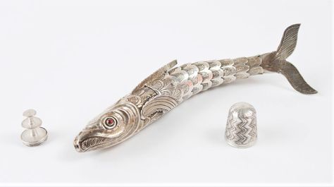 This sterling silver articulated fish is really an étui. The fish has garnet eyes and holds a thimble, a petite thread reel and needles. It was made in German in the 1800s and measures 14cm by 2cm (5.5 by .75 inches). You can see more photos of this piece at https://www.millon.com/lot/24463/5321292?offset=80& Sterling Silver Articulated Fish, Articulated Fish, Cool Objects, Ideas For Jewelry, Silver Fish, Art Quilt, The Fish, Art Quilts, Making Jewelry