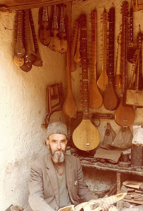 Title: Instrument Maker  Description: Juma Khan poses in his Instrument shop in Shor Bazaar, a Rubab in hand.  ... Afghan People, Afghanistan Culture, Afghan Culture, Kabul Afghanistan, Music Project, Western Asia, Vintage Blog, Hand Photo, Folk Instruments