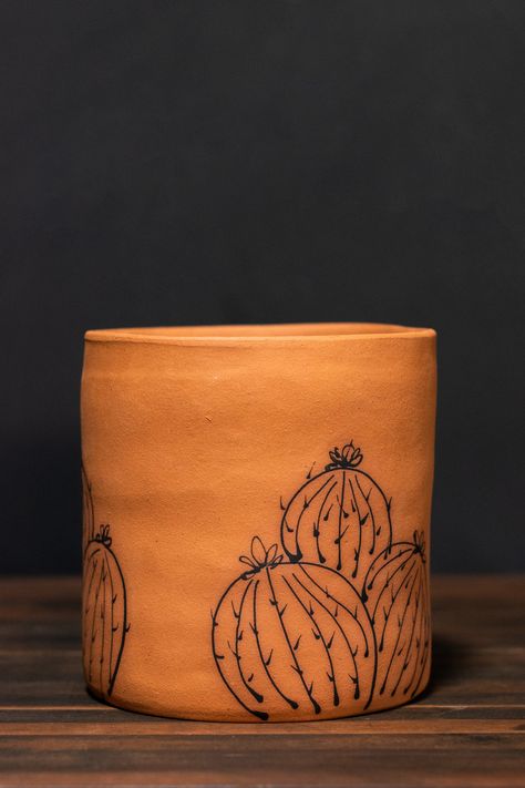 Available for shipping! High quality, hand-constructed planters built from beautiful raw clay harvested by the artist in the Pacific Northwest. Each planter features a unique, hand-painted design depicting Barrel Cacti of all shapes and sizes.Each one-of-a-kind planter contains a drainage hole for healthy roots and proper aeration. DIMENSIONS• 2”: Fits a 2” diameter grow pot.• 4”: Fits a 4” diameter grow pot.• 6": Fits a 6" diameter grow pot.Handcrafted in small batches. Natural variations shoul Southwest Planters Pots, Boho Painted Plant Pots, Terracotta Pot Painting Ideas, Hand Painted Pots, Ceramics Artist, Painted Planter, Az Art, Painted Frames, Hand Painted Planter