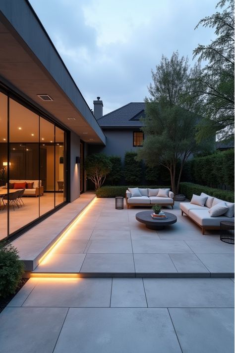 Contemporary backyard patio with large porcelain tiles, minimalist furniture, and LED lighting Modern Backyard Patio, Patio Materials, Contemporary Backyard, Patio Oasis, Integrated Lighting, Patio Design Ideas, Vibrant Decor, Patio Projects, Modern Backyard