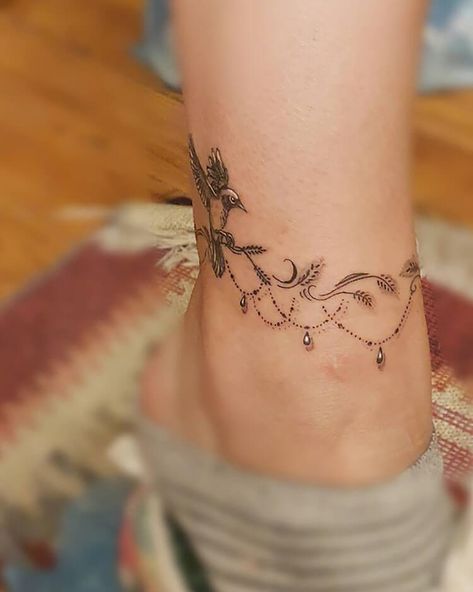 Ankle Bracelet with a Bird Design Chain Bracelet Tattoo Wrist, Dragonfly Anklet Tattoo, Fine Line Anklet Tattoos, Tattoo Anklet Ideas, Anklet Tattoo With Charms, Floral Ankle Bracelet Tattoo, Floral Tattoo Ideas For Women, Woman’s Ankle Tattoo, Butterfly Anklet Tattoo