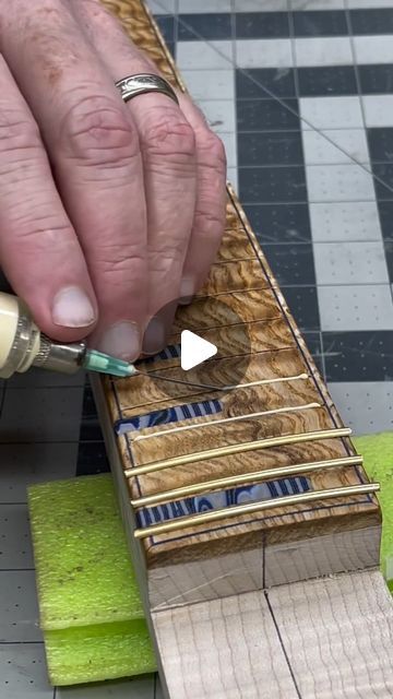 Fret Me Nought on Instagram: "Here's a clip of @shockthefox laying down some gold wire on a stunning fretboard On the hunt for new gear? Head over to the @ploutone.guitar shop in our bio to see what's in stock!🤘 . . . . . . . . . . . . . . . #guitar #headlessguitars #handmadeguitar #multiscale #boutiqueguitars #customguitar #djent #prog #guitarporn #instaguitars #fannedfret #headlessguitar #boutiqueguitar #customguitars #guitarsofinstagram #guitarstagram #extendedrangeelites #fretmenought #7string #handmadeguitars #guitarspotter #electricguitar #6string #guitars #luthier #instaguitar #electricguitars #guitardaily" Luthier Workshop, Luthier Guitar, Guitar Making, Boutique Guitar, Handmade Guitar, Guitar Shop, Custom Guitar, Custom Guitars, Gear Head