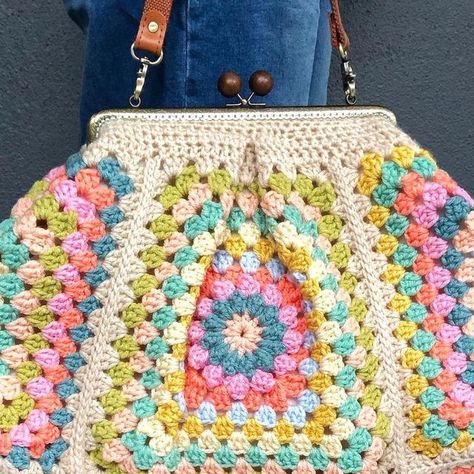 Megan Ballarini on Instagram: "I’m Mary Poppins, y’all! I adore the shape of this bag, it is VERY roomy!  I made it in my favorite happy colors and the kiss lock clasp and flower centers are so fun! I lined it with a vintage sheet for the perfect finishing touch. This bag is inspired by @kedito #poppinsbag, I made mine much smaller than hers but it still came out bigger than I expected! I could fit all my necessities in here but probably not a coat stand 🤣" Kiss Lock Crochet Purse, Crochet Pansy Bag, Kisslock Coin Purse Crochet, Marni Crochet Bag, Multicolor Handmade Vintage Crochet Bag, Coat Stand, Coat Stands, The Kiss, Vintage Sheets