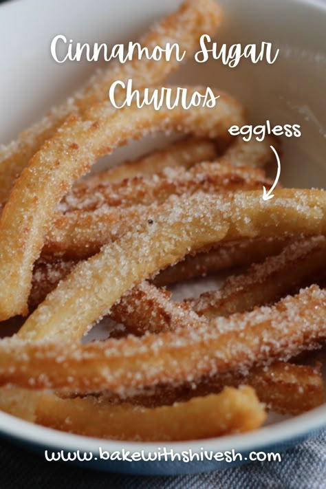 Each bite of this dish brings about an explosion of tastes in your mouth with the cinnamon and sugar coating, crispy outside and the tender center, one finds himself in heaven when they have it with a semi-sweet chocolate fondue. Eggless Churros, Make Churros, Eggless Dessert Recipes, Bake With Shivesh, Baked Churros, Eggless Cookies, Churros Recipe, Eggless Desserts, Eggless Recipes