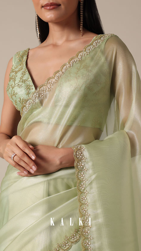 "Step into sophistication with this Graceful Green Tissue Saree. It is featuring meticulous bead and cutdana work on a scalloped border. The light green and glass tissue accents enhance the overall appeal, creating a perfect choice for your party wear collection. Meticulous detailing and the inclusion of unstitched blouse fabric ensure a customized fit.
" Blouse Designs For Green Saree, Glass Tissue Dresses, Scallop Border Saree, Saree Designs Party Wear Wedding, Blouse Design For Fancy Saree, Pelli Choopulu, Gold Tissue Saree, Light Green Saree, Cutdana Work