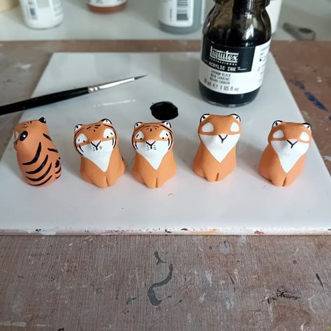 Some tiny tigers on the way...just adding the finishing touches 🐯 . . #clay #clayart #airdryclay #sculpture #claysculpture #artsandcrafts #animalart #pottery #potteryanimals #wildlife #animals #clayanimals #cute #cuteanimals #figures #figurines #ornaments #miniature #miniatures #miniaturesculpture #miniatureanimals #minis #totem #wildlifeart #workinprogress #etsy #etsyuk #fallingfauna Air Dry Clay Figurine, Mini Clay Figures, Tiny Clay Sculptures, Air Dry Clay Animals, Air Dry Clay Figures, Airdryclay Ideas, Clay Tiger, Mini Animals, Clay Inspo