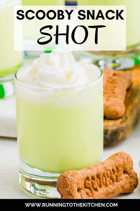 This Scooby Snack Shot is the perfect nostalgic party drink! Made with Midori melon liqueur, coconut rum, pineapple juice, and cream, this vibrant Scooby Snack drink will bring back memories of Saturday morning cartoons. Top the Scooby shot recipe with whipped cream and a Scooby Snack graham cracker for a fun, playful touch. Easy to make and perfect for any gathering, this Scooby Snack Shot will have everyone talking and reminiscing about their favorite childhood moments! Scooby Snack Shot Recipes, Scooby Snack Drink, Scooby Snack Shot, Midori Melon, Spooky Halloween Food, Graham Cracker Cookies, Melon Liqueur, Easy Drink Recipes, Delicious Drink Recipes