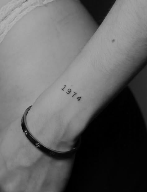 Delve into the significance of a number tattoo on the outer wrist, paying tribute to the year 1974. This fineline design adds a personal touch and meaningful element to the wearer's ink. Follow us for more tattoo inspiration and ideas! #NumberTattoo #OuterWristInk #FinelineDesign #TattooInspiration Tattoo image credit - @rbn_says Discover a variety of tattoo styles, trends, and meanings on our website! 333 Tattoo On Wrist, 333 Tattoo Wrist, 1974 Tattoo Number, Year Number Tattoo, 222 Tattoo On Wrist, Tattoo Ideas Numbers, 222 Angel Number Tattoo Wrist, Upper Wrist Tattoo, Small Number Tattoo