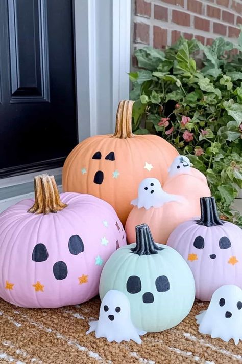 Four pastel pumpkins with ghost candels sitting on a doorstop. How To Paint A Pumpkin For Halloween, Pumpkin Painting Ideas Minimalist, Painting Pumpinks Ideas Easy, Easy Halloween Carving Pumpkin Ideas, Pumpkin Painting Ideas For White Pumpkins, Tiny Painted Pumpkins Ideas, Easy Painting Ideas On Pumpkins, Decorate Small Pumpkins Ideas, Ideas For Painted Pumpkins