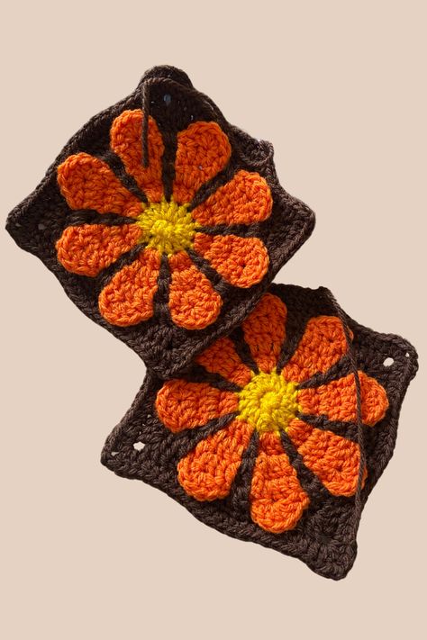 I’m working on a cozy, 70s-inspired blanket for a family member using my Retro Daisy Granny Square! These bright orange and brown squares bring such a nostalgic vibe, perfect for adding warmth and style. Get the free pattern on audtracreations.com and start creating your own vintage masterpiece! ✨ #RetroCrochet #GrannySquare #FreePattern #CrochetCommunity #AudtraCreations Granny Square 70s, 70s Flower Granny Square, 70s Inspired Crochet Patterns, Orange Yarn Crochet Ideas, Retro Granny Square Blanket, Retro Daisy Granny Square Pattern Free, Retro Flower Granny Square, Retro Crochet Patterns, Granny Square Blanket Free Pattern