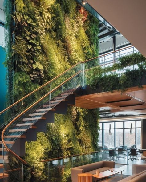 This lush green wall brings the otherwise bland corporate space to life. Whether real or faux, visuals of green in a space calm the mind and promote feelings of wellness. Biophilic Interior Design Office, Nature Office Design, Greenwall Interior Design, Tropical Office Design, Biophilia Office, Business Office Interior Design Work Spaces, Biofilia Interior Design, Biophilic Design Interiors, Biophilic Office Design