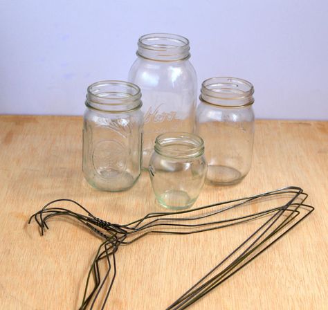 Oh my, LOVE this... Coat hangers and mason jars turned rustic hanging lanterns. | "Easiest DIY Hanging Mason Jar Lights - A Piece Of Rainbow" Diy Hanging Mason Jar, Hanging Mason Jar Lights, Mason Jar Lights, Chalk Paint Mason Jars, Mason Jar Projects, Hanging Mason Jars, Mason Jar Flowers, Jar Lanterns, Wine Bottle Diy Crafts