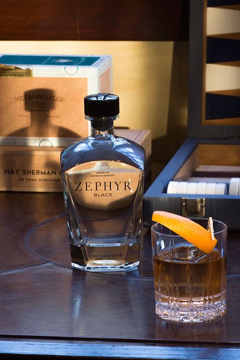 2 oz Zephyr Black Gin, .5 oz simple syrup, 2 dashes Angostura Bitters and an orange peel. Add Zephyr Black Gin, simple syrup and bitters into a mixing glass with ice and stir until well chilled. Strain into an old fashioned glass with one large ice cube and garnish with an orange peel. Gin Old Fashioned, Angostura Bitters, Old Fashioned Glass, Old Fashion, Orange Peel, Simple Syrup, Ice Cube, Syrup, Gin