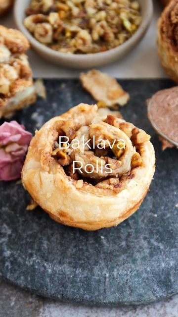 Alia & Radwa on Instagram: "These Baklava Rolls are the ultimate hack to making baklava! We use puff pastry to give it that crispy, flakey, and buttery texture that we all love from a traditional baklava! Plus, it’s so easy to put together! Recipes 1 sheet puff pastry, slightly thawed 3 tbsp butter or ghee, softened 1 1/2 tsp ground cinnamon 1 tbsp granulated sugar 1/4 cup finely chopped toasted pistachios 1/4 cup finely chopped toasted walnuts 1 egg, beaten Honey, to taste Preheat oven to 4 Baklava Puff Pastry Rolls, Baklava Puff Pastry Recipe, Baklava Puff Pastry Cinnamon Rolls, Pistachio Puff Pastry Dessert, Banana Balls, Baklava Rolls, Toasted Pistachios, Holiday Breads, Greek Dessert