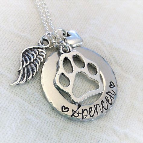 "Personalized Pet Memorial Necklace, Dog, Cat, In Memory Of Necklace, Remembrance Jewelry, Pet Memorial Jewelry, Angel Pet Necklace, Handmade This piece features ■ One 1 1/8\" washer style hand stamped pendant with name of your choice ■ One Tibetan silver paw charm ■ One Tibetan silver angel wing charm ■ Your choice of chain What I need from you, in the notes box at checkout ■ Name of your pet Each letter and design is hammered and finished one by one, by my husband and myself. Please understand Cat Memorial Jewelry, Paw Jewelry, Dog Lover Jewelry, Pet Memorial Necklace, Slumped Glass, Remembrance Jewelry, Pet Memorial Jewelry, Woven Necklace, Personalized Pet Memorial