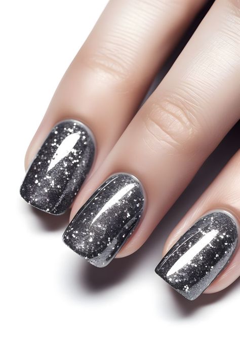 steel gray nails, glittery nails, sparkly nail ideas, nail art inspo, gray nail designs, New Year's nails, nail trends, nail inspiration, holiday beauty, nail goals, nail fashion, festive nails, winter nail inspo, seasonal nails, nail ideas, nail creativity, party nails, elegant nails, glamorous nails, trendy nail designs, chic nails, beautiful nails, stylish nails, nail magic, fabulous nails Dark Grey Christmas Nails, Dark Grey Sparkle Nails, Dark Grey Nails With Design, Glitz And Glam Nails, Dark Silver Nails, Festive Nails Winter, Gray Glitter Nails, Dark Gray Nails, Sparkly Nail Ideas