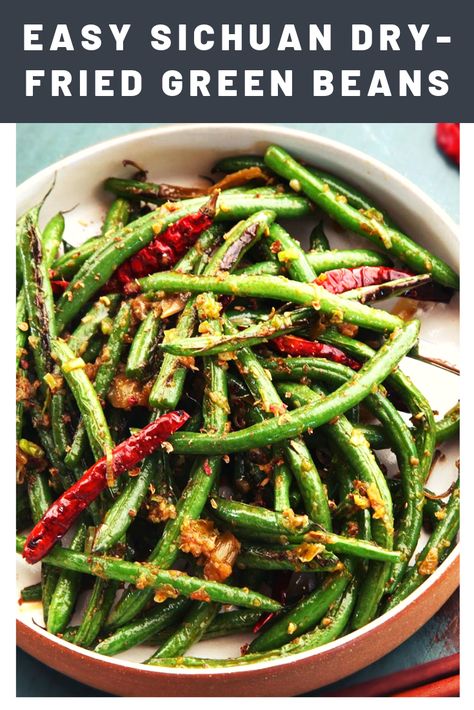 Easy Sichuan Dry-Fried Green Beans (Gan Bian Si Ji Dou) | Thanksgiving dinner only needs to be as traditional as you want it to be—I like using the holiday to introduce my friends and family to flavors they might not be used to. This not-so-classic side gives Thanksgiving so Sichuan flair by coating blistered green beans in a fiery peppercorn-infused oil.	  #thanksgiving #thanksgivingrecipes #thanksgivingdishes #seriouseats #recipes Asian Fusion Thanksgiving, Asian Thanksgiving Dishes, Asian Beans, Asian Thanksgiving, Spicy Green Bean Recipes, Chinese Garlic Green Beans, Blistered Green Beans, Dry Fried Green Beans, Winter Holiday Recipes