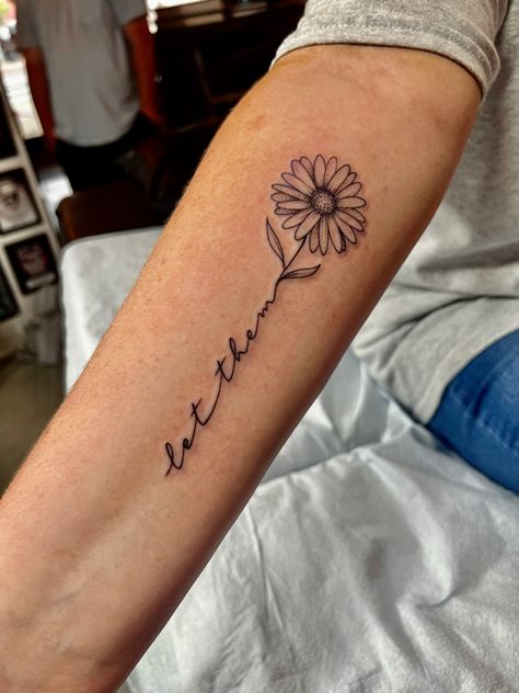 Grace Wrist Tattoos For Women, Let Them Sunflower Tattoo, Let Them With Flowers Tattoo, 1 Word Tattoos For Women, Sunflower Tattoo With Name In Stem, You Saved Me Tattoo, Tattoos For Side Of Arm, Let Them Flower Tattoo, Let Them Tatoos