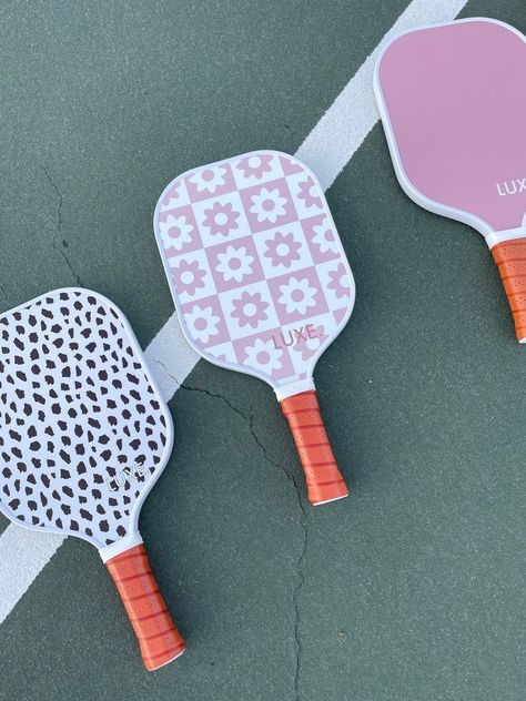 Good looks and even better performance! Painted Pickleball Paddle, Cute Pickleball Paddles, Preppy Pickleball, Pickleball Aesthetic, Pickle Ball Paddle, Bridesmaid Baskets, Preppy Sports, Checkered Flower, Homecoming Poses