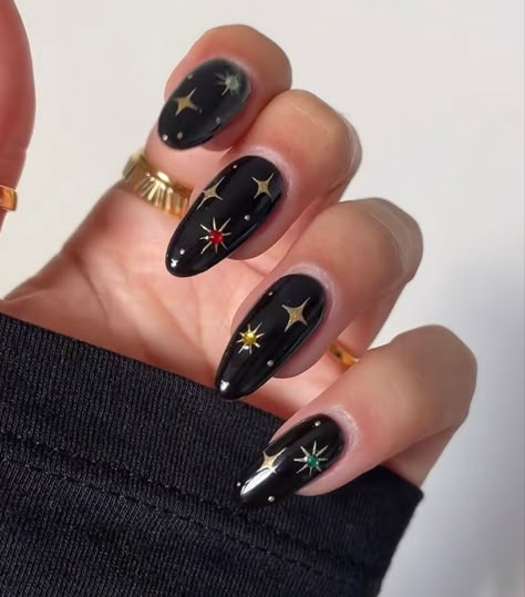 December Nails Short Almond, Black Gold Star Nails, Moody Acrylic Nails, Engagement Nails Colorful, Classy Witchy Nails, Dark Nails With Stars, Black And Gold Witchy Nails, Fall Celestial Nails, Witchy Inspired Nails