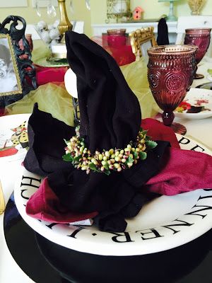 witch hat napkins, witch tablescape, Witchy tablescape, Halloween decorations, The Style Sisters Witchy Tablescape, Witch Tablescape, Halloween Napkin Folding, Witch Centerpiece, Walmart Halloween, Pioneer Woman Dishes, Fun Plates, Halloween Napkins, Black And White Plates