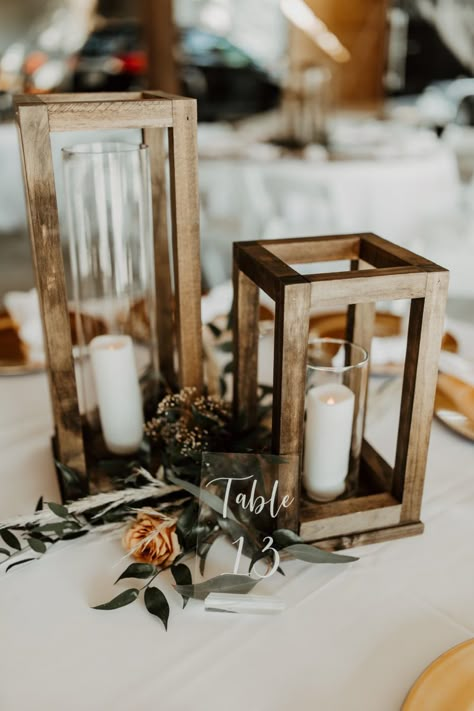 Square Wood Centerpieces Wedding, Wooden Wedding Lanterns, Rustic Lantern Wedding Centerpieces, Wood Candle Centerpiece Wedding, Simple Wedding Centerpieces Lanterns, Simple Cheap Centerpieces Wedding, Navy And Rust Table Decor, Lantern Fairy Lights Centerpiece, Wood Lantern Table Centerpieces