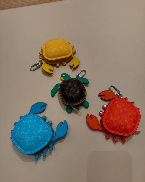 Available in four vibrant colors, this eminently giftable LV Crab Bag Charm brings an uplifting burst of summer color to a favorite bag. A beautifully crafted addition to the growing menagerie of Louis Vuitton animal charms, this playful piece is meticulously assembled from leather with an allover Monogram canvas finish to the body. Introducing the LV Turtle pouch, a fun, functional accessory. Made from Monogram canvas, colorful leather and a silver-tone snap hook, the friendly creature can... Crab Bag, Bag Charms, Summer Color, Functional Accessories, Colored Leather, Summer Colors, Monogram Canvas, Crab, Silver Tone