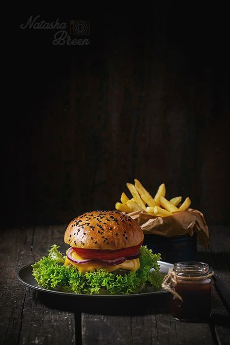 Homemade Hamburger - Fresh homemade hamburger with black sesame seeds in old metal plate with fried potatoes, served with ketchup sauce in glass jar over old wooden table with dark background. Dark rustic style. Hamburger Gourmet, Design Cibo, Burger Photography, Gourmet Burger, Dark Food Photography, Homemade Hamburger, Food Photoshoot, Homemade Hamburgers, Gourmet Burgers