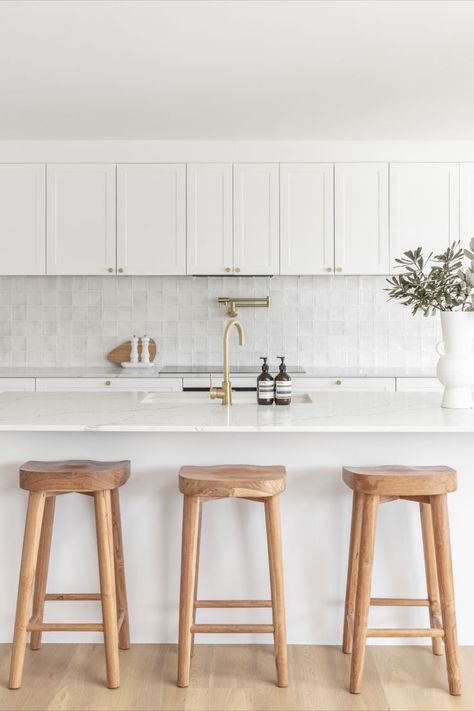 A white kitchen filled with natural light features brushed brass tapware and wooden bar stools. Timeless Kitchen Ideas, Abi Interiors, Bathroom Tapware, Interiors Kitchen, Dream Kitchens Design, Shower Head Holder, Concrete Basin, Back To Wall Bath, Kitchen Sink Taps