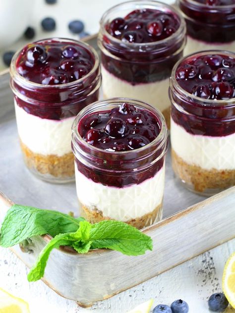 Blueberry Lemon No Bake Cheesecake - Yummy, healthier, no-bake cheese cake in a mason jar!  Lightened up with a graham cracker almond crust, a sweet cream cheese lemony Greek yogurt layer, and a delightful homemade blueberry sauce.  #grahamcrackers #creamcheeses #recipe #dessert #pie #berries #summer #blueberries #tasteandsee || https://tasteandsee.com || Lemon No Bake Cheesecake, Cheesecake Jars, Mason Jar Desserts, Cheesecake In A Jar, Cheesecake Cups, Homemade Cheesecake, Dessert In A Jar, Blueberry Desserts, Mason Jar Meals