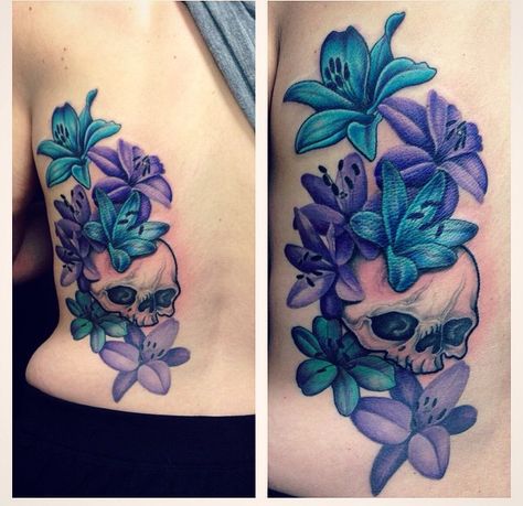 Skull and lily back tattoo. Colourful purple and blue lily with black and grey shade back tattoo. Skull And Lilies Tattoo, Purple Lillies Tattoo, Blue And Purple Rose Tattoo, Kindered Spirts, Blue And Purple Flower Tattoo, Purple And Blue Tattoo, Blue Lily Tattoo, Lily Back Tattoo, Tattoo Colourful