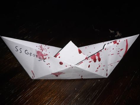 Top offer of the season! S S Georgie origami paper boat, now at an exclusive price of $6.00 #StephenKingFans #OrigamiArt #SsGeorgie #HandmadeCrafts #pennywise #CollectibleOrigami #SSGeorgieBoat #it #oragami #PaperBoat Pennywise Decorations, Horror Movie Room, Derry Maine, Diy Crafts For Boyfriend, Ocean Candle, Paper Boats, Horror Literature, Corn Husk Dolls, Movie Room Decor