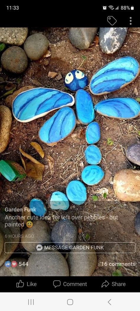 Painted Rock Designs In Gardens, How To Decorate Garden With Stones, Flower Rock Garden, Rock Flowers In Garden Stone Art, Outside Play Area Ideas, Rock Dragonfly Garden Stones, Rock Garden Flowers, Beautiful Garden Ideas Diy Projects, Painted Rock Garden Landscaping