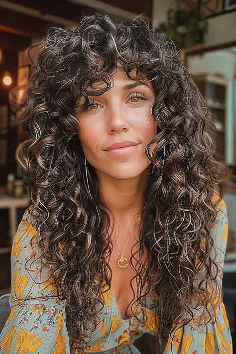 Long boho shag hairstyle with voluminous natural curls and a layered cut Curly Shag No Bangs, Curly Shag With Curtain Bangs, Long Curly Shag With Bangs, Shaggy Curly Hair Long, Long Curly Shag Haircut, Curly Shag Haircut Medium, Warm Caramel Highlights, Curly Shag With Bangs, Shaggy Curly Hair