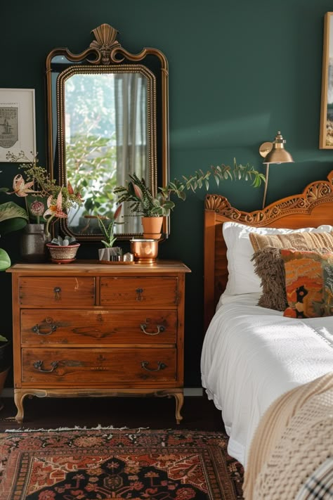 Cozy sage green bedroom featuring dark green walls, a vintage wooden dresser, and a mix of lush houseplants for a calming atmosphere. Emerald And Blue Bedroom, Green And Rust Bedroom Ideas, Elegant Cozy Bedroom, How To Make A Room Cozy, Sage Green Walls Bedroom, Green Bedroom Curtains, Vintage Bedroom Decor Ideas, Vintage Bedroom Aesthetic, Vintage Decorating Ideas