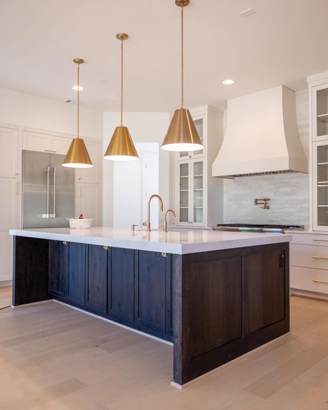 Harrison Homes on Instagram: “The rich, dark wood of the custom kitchen island contrasts beautifully with the light cabinets and backsplash. And, notice the brass…” Dark Stained Island White Cabinets, Light Kitchen Dark Island, Dark Island Light Cabinets, Dark Island White Cabinets, Dark Wood Kitchen Island, Dark Stained Island, Dark Wood Island, Light Cabinets, Dark Island