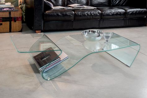 The Alaric coffee table is a geometrically inspired masterpiece that seamlessly pairs together art and function. Reminiscent of a piece of origami, Alaric is made out of monolithic glass that looks fragile, but is durable and designed for longevity. The angled sloped shelf is built into the table and is the perfect place for reading materials, remotes, and other small items. Manufactured in Italy with incredible attention to detail, the Alaric coffee table by Tonin Casa is a modern m Glass Living Room Table, Glass Table Living Room, Lucite Coffee Table, Lucite Coffee Tables, Italian Furniture Modern, Reading Materials, Minimalist Furniture, Studio Design, Contemporary Glass