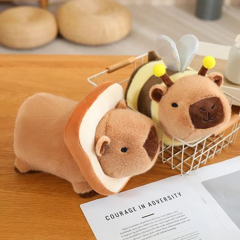 Description FAQ Shipping Cuddle the cutest Baby Capybara plushies ever Designed to transform your cozy dreams into reality! Embrace the warmth and joy these adorable capybara plushies offer – soft, smiley, and ready to shower you with love and snuggles. Immerse yourself in the delight of companionship without any hassle, surrounded by a variety of accessories for endless cuddles.With a choice of 5 funny designs and 2 different sizes, our kawaii Capybara plushies are the ideal gift, creating last Kawaii Things To Buy, Capybara Plushies, Capybara Plushie, Kawaii Capybara, Baby Capybara, Capybara Plush, Bee Wings, Kawaii Plushies, Kids Birthday Gifts