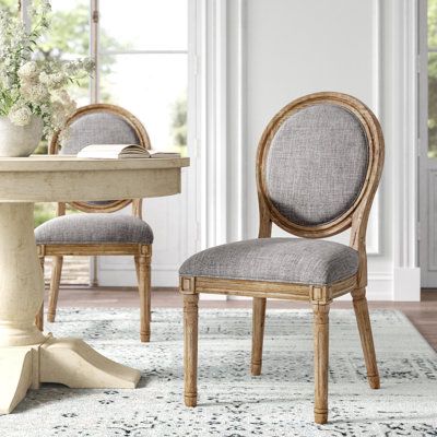 This set of two side chairs adds a few more seats in your living room when you have guests — and it can also feel right at home at your kitchen nook or dining room table. These chairs have a solid pine wood frame in a light brown finish, with turned, chamfered legs and additional carved details. The solid round backs feature a linen-upholstered inset along with the seat. Both are filled with foam to provide additional support as you enjoy brunch or conversation with family and friends. Hand-cura Round Back Dining Chairs, Kelly Clarkson Home, Chair Wood, Upholstered Side Chair, Wood Sideboard, Kelly Clarkson, Upholstered Fabric, Armchair Design, Kitchen & Dining Chairs